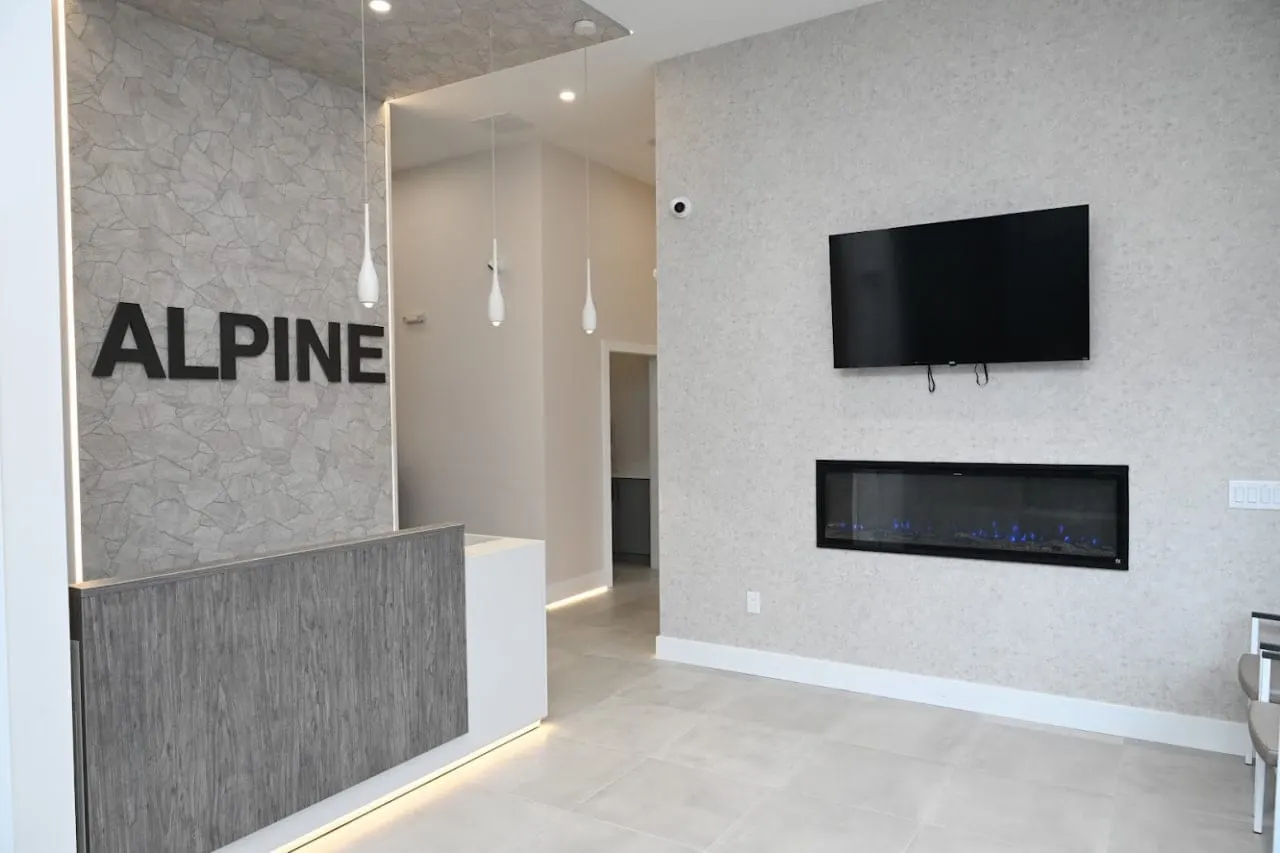 Reception desk and waiting room with a fireplace at the Alpine Dental office in Jackson, NJ