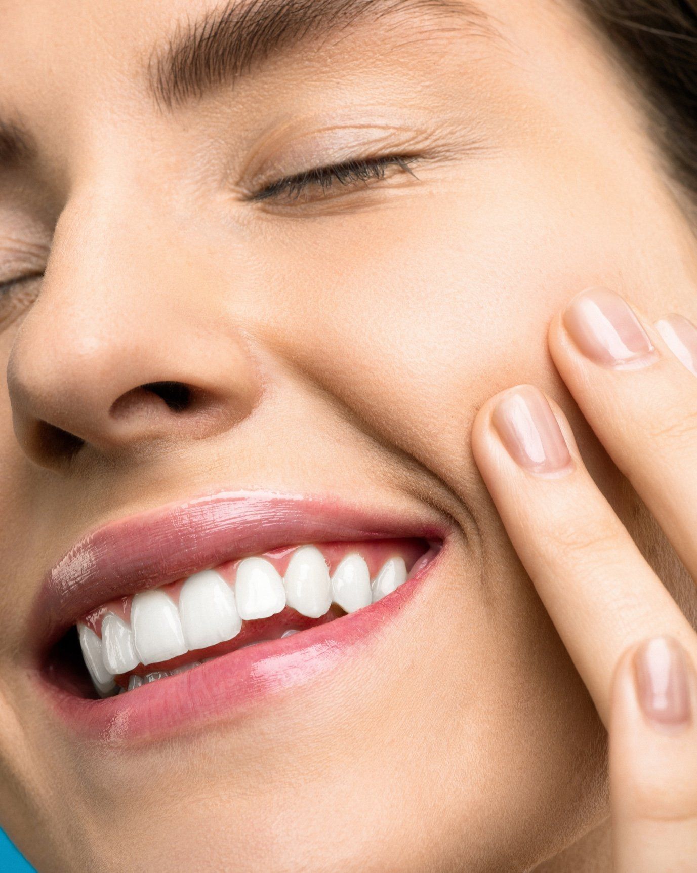 Close-up of porcelain veneers being placed